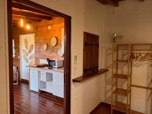 a kitchen with a counter and a shelf in a room at Bungalow avec jacuzzi privatif in Sainte-Rose