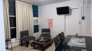 a living room with a table and chairs and a television at Lo de ANNA in Posadas