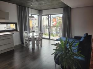 a living room with a table and a dining room at Loft 66 Apartamenty in Władysławowo