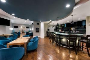 a restaurant with blue chairs and a bar at Suburban Studios in San Angelo