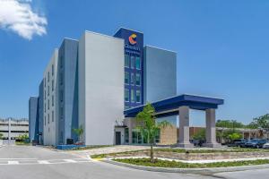 a large office building in a parking lot at Comfort Inn & Suites New Port Richey Downtown District in New Port Richey