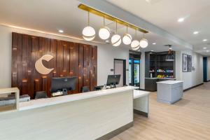 an office lobby with a reception desk and lights at Comfort Inn & Suites New Port Richey Downtown District in New Port Richey