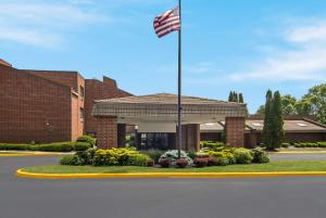 an american flag flying in front of a building at The Inn on Maritime Bay, Ascend Hotel Collection in Manitowoc