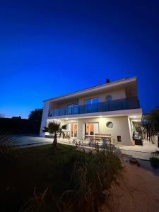 a large house at night with the lights on at Villa MARIGI in Medulin