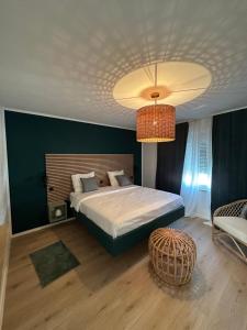a bedroom with a large bed and a chandelier at Villa MARIGI in Medulin