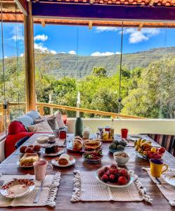 uma mesa com comida e vista para as montanhas em Casa com Vista para Montanhas - C Diamantina em Palmeiras