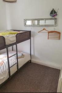 a room with two bunk beds in a room at Middleway Cottage in Saint Blazey