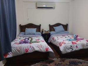 Postel nebo postele na pokoji v ubytování Malak Guest House