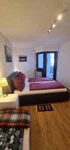 a bedroom with a large bed and a couch at Apartment Panorama in Bad Reichenhall