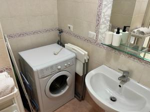 a bathroom with a washing machine and a sink at Casa Domus del Chirurgo in Rimini