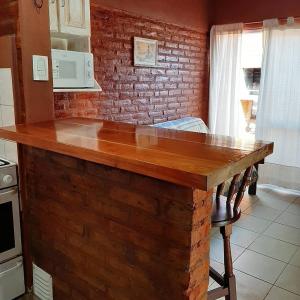 - une cuisine avec un comptoir en bois dans l'établissement Cabañas Gemas del Lago, à Potrero de los Funes