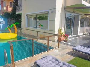 a house with a swimming pool in front of a house at Τάνια in Anavyssos