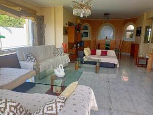 a living room with a couch and a table at Τάνια in Anavissos