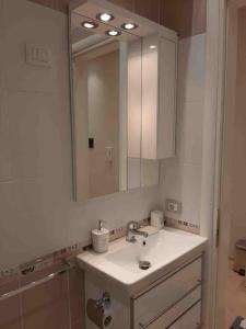 a bathroom with a sink and a mirror at Sea View Apartment with Veranda Beach Amazing in Vlorë