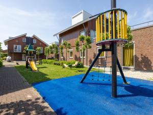 a playground with a slide on a blue carpet at Tiny houseboat Uitgeest I in Uitgeest