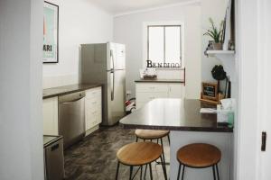 a kitchen with a table and two stools at Hargreaves Cottage - close to CBD in Bendigo