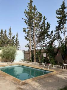 a swimming pool in a yard with trees at Villa for daily rent فيلا للكراء اليومي in Marrakesh