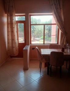 a living room with a table and a window at Villa for daily rent فيلا للكراء اليومي in Marrakesh