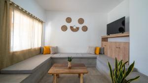 a living room with a couch and a table at Coco Surf Tropical Village in La Libertad