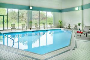 a pool in a hotel room with chairs around it at Travelodge by Wyndham Ottawa East in Ottawa