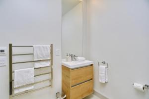 a bathroom with a sink and a mirror at Worcester Terrace One - Christchurch Holiday Homes in Christchurch +27 photos