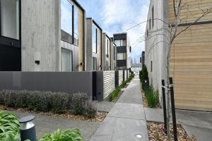 a sidewalk in front of a building with buildings at Worcester Terrace One - Christchurch Holiday Homes in Christchurch