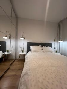 a bedroom with a large bed with two tables at Boutique Serenity in Cluj-Napoca