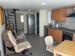 a kitchen with a table and chairs and a refrigerator at Pontevedra Centro adosado in Pontevedra +11 photos