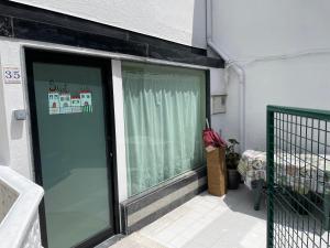 a glass door of a building with a window at Pontevedra Centro adosado in Pontevedra