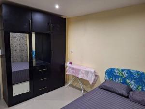 a bedroom with a bed and a cabinet and a chair at Stunning Two-Bedroom: Perfect Home Away from Home in Suva