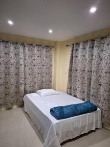 a bed in a room with curtains and a bed sidx sidx sidx at Stunning Two-Bedroom: Perfect Home Away from Home in Suva