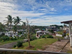 a view of a town with houses and a tree at Stunning Two-Bedroom: Perfect Home Away from Home in Suva