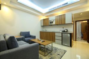 a living room with a couch and a table at La Richy Jeddah in Jeddah