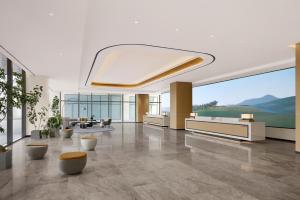 a living room with a large window and a lobby at Courtyard by Marriott Sejong in Sejong