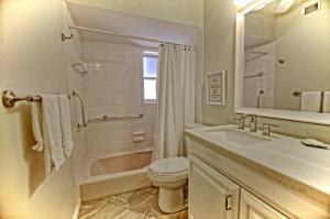 a bathroom with a sink and a toilet and a tub at Gulfside Resort. Unit 1 in St. Pete Beach +20 photos