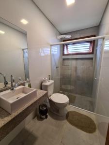 a bathroom with a sink and a toilet and a shower at Barra Grande Bangalôs in Marau
