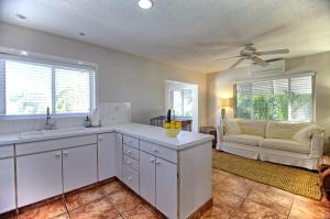 a kitchen with a sink and a couch in a room at Gulfside Resort Unit 2 in St. Pete Beach