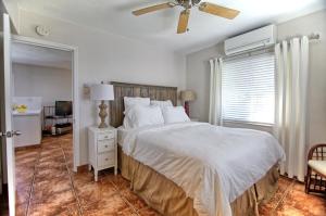 a bedroom with a bed and a ceiling fan at Gulfside Resort Unit 2 in St. Pete Beach +20 photos
