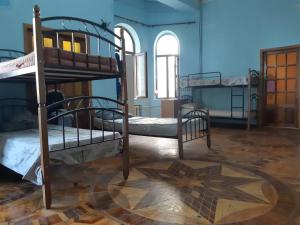 a room with two bunk beds and a star on the floor at BAKU GUEST HOSTEL in Baku