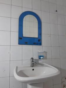 a bathroom sink with a blue mirror on the wall at BAKU GUEST HOSTEL in Baku