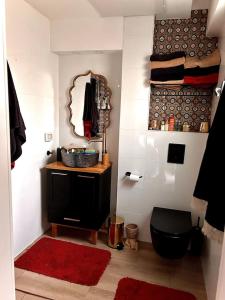 a bathroom with a black toilet and a mirror at 2BDR-Wonderful Flat on Margoza in Tel Aviv