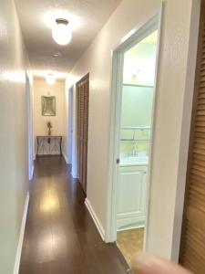 a hallway with a bathroom and a sink in a house at THE MANONO HOUSE - Peaceful, Private 3Bd 2Bath Home near HILO, with AC! in Keaau