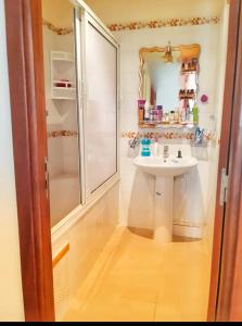 a small bathroom with a sink and a shower at Résidence al massirra in Fnidek