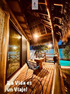 a deck with a chair and a table on it at A&V Hotel Boutique in Acapulco