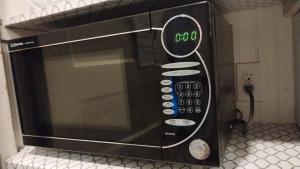 a microwave oven sitting on top of a counter at Cool and affordable apartment Galesburg in Galesburg