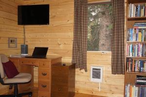 a room with a desk with a laptop and a window at Beautiful Mountain Cabin near Tetons Yellowstone in Dubois