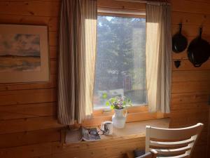a window in a room with a table and a vase of flowers at Beautiful Mountain Cabin near Tetons Yellowstone in Dubois +19 photos