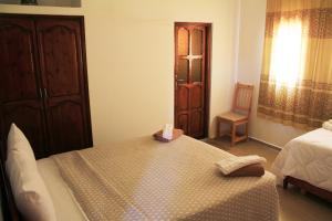 a bedroom with a bed with a box on it at Riad Ouinz in Aït Benhaddou
