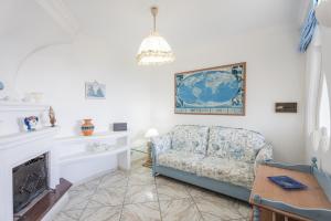 a living room with a chair and a fireplace at Emozioni Capresi Guest House in Capri