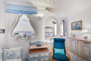 a living room with a table and a chair at Emozioni Capresi Guest House in Capri